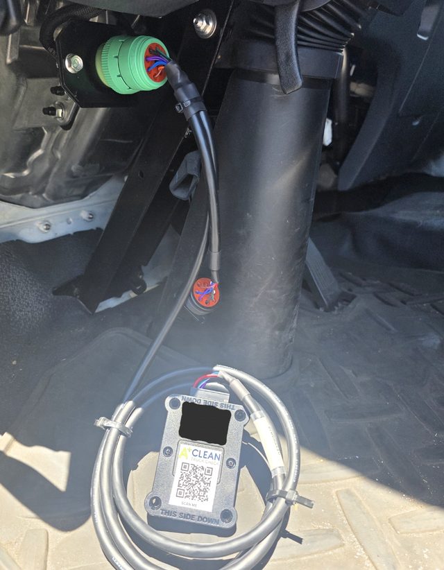A branded A+ Plus CC40 installed in a truck cab, plugged into the green J1939 diagnostic port